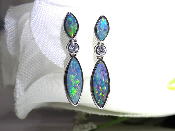 This is a women's high quality boulder opal dangle earrings bezel set in 14K white gold with diamonds for a total weight of 1.50ct on a white background.
