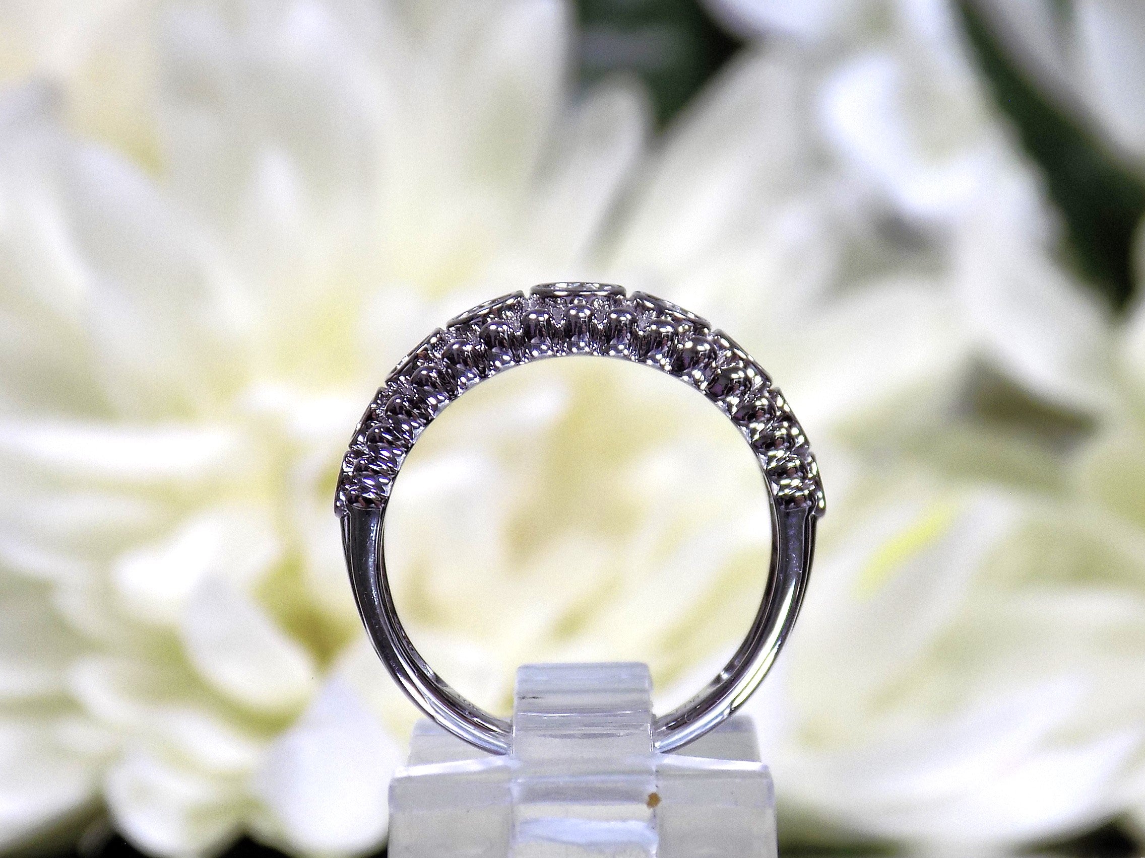 .20ct bezel set natural round brilliant diamond ring in 10K white gold side view.