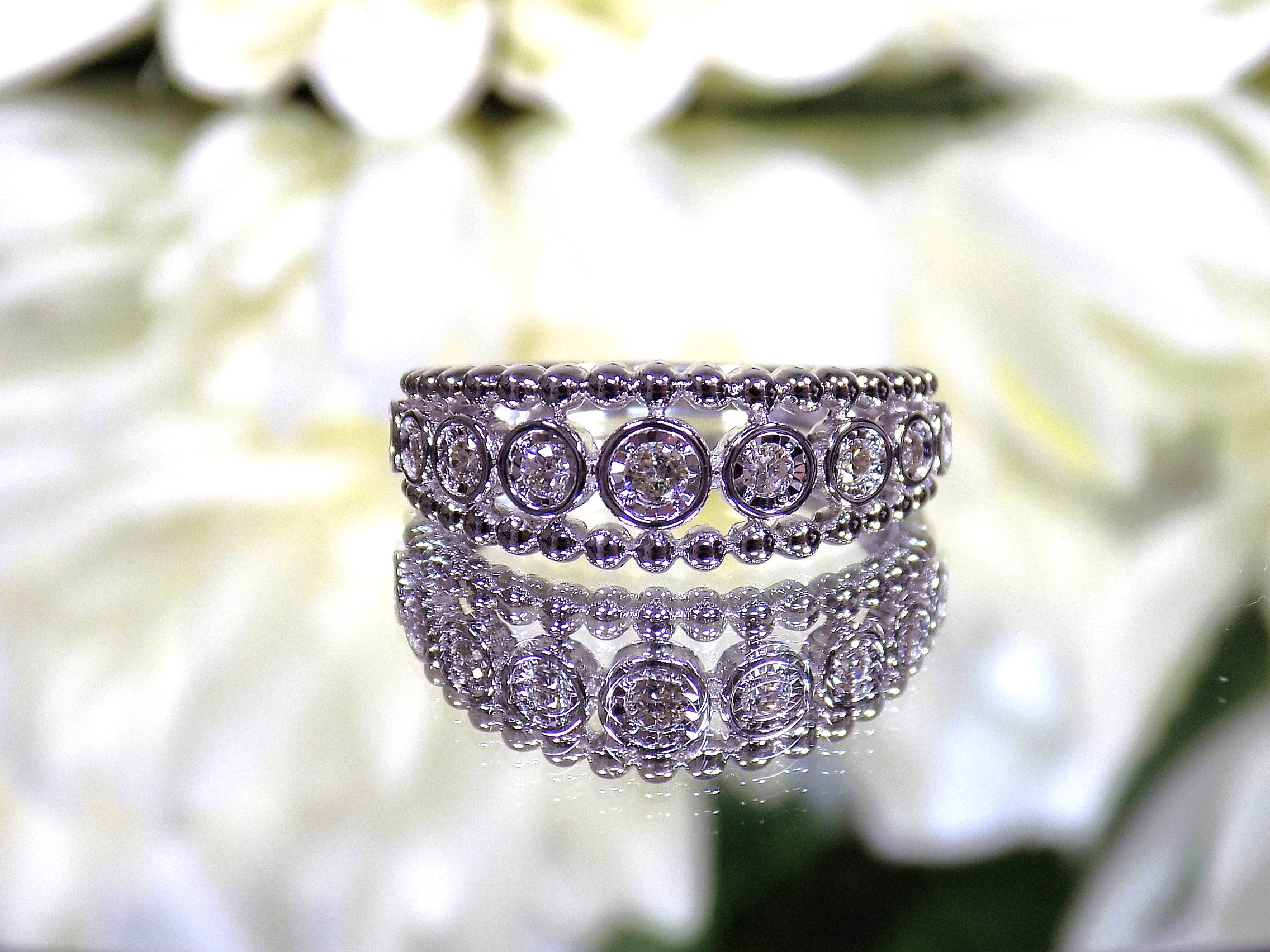.20ct bezel set natural round brilliant diamond ring in 10K white gold.