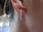 This is .50ct total weight natural diamond inside out hoop earrings in 10K yellow gold in a ladies ear.