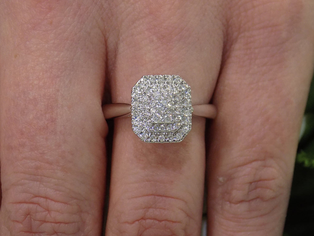 .50ct total weight natural diamond cluster ring in 10K white gold on a ladies  finger.