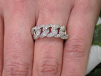 This is a .50ct natural pave set round diamond band in white gold on a woman's finger.