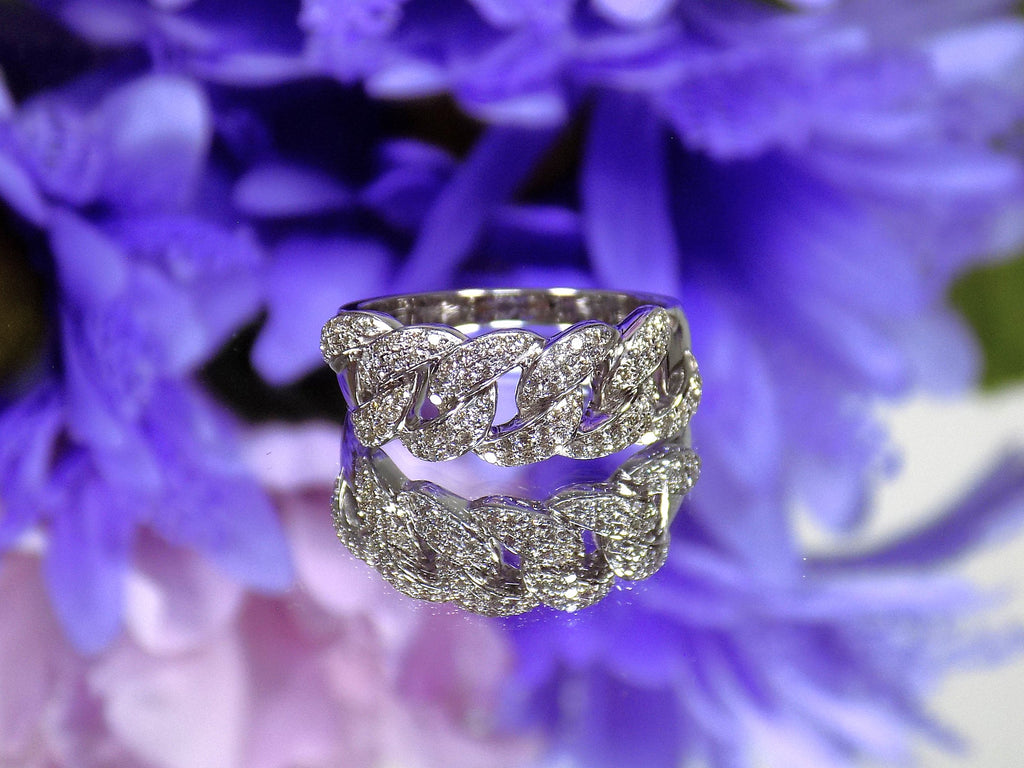 This is a .50ct natural pave set round diamond band in white gold with a blue mirrored flowery background.