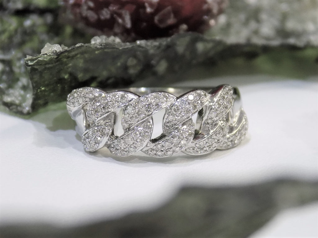 This is a .50ct natural pave set round diamond band in white gold with flowery background.