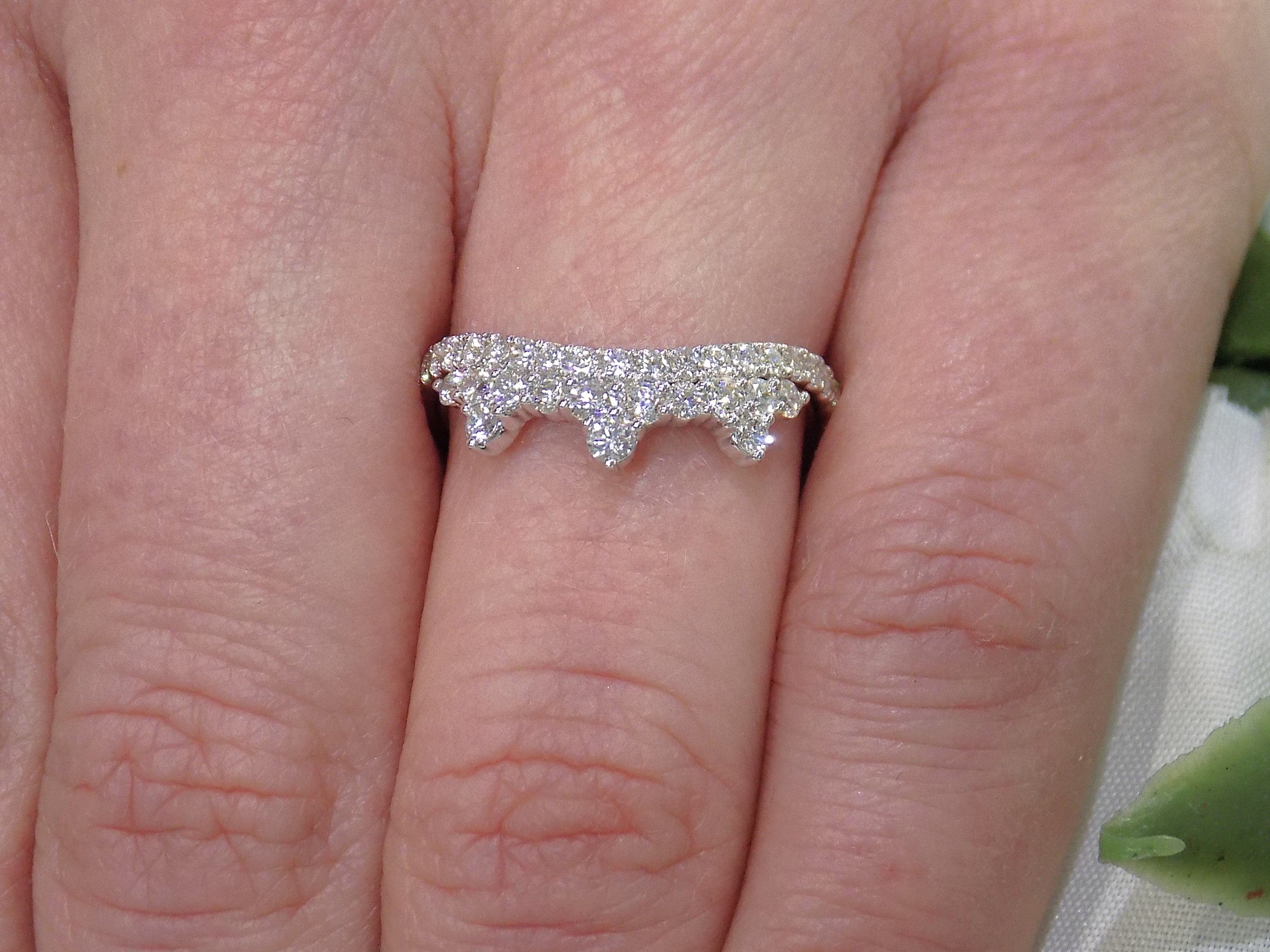 .63ct total weight natural round brilliant diamond tiara style ring in 14K white gold on a ladies finger.