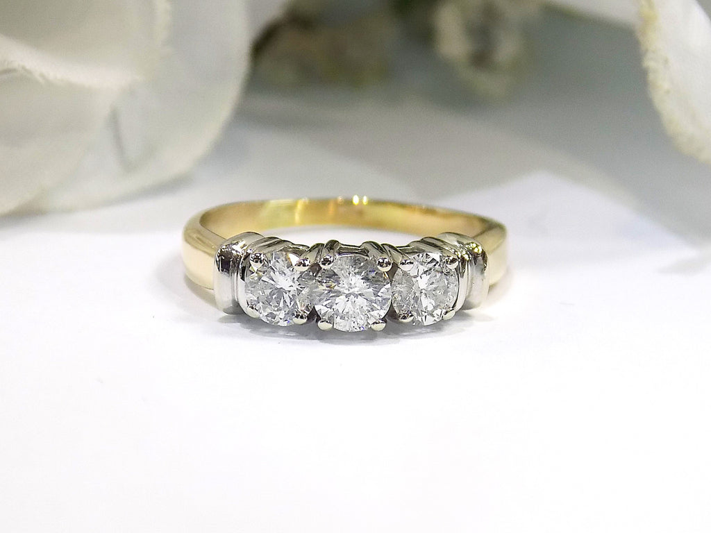 1.00ct total weight 3 stone natural diamond ring in 2 tone 14K yellow and white gold. Traditionally called a past, present, future ring.
