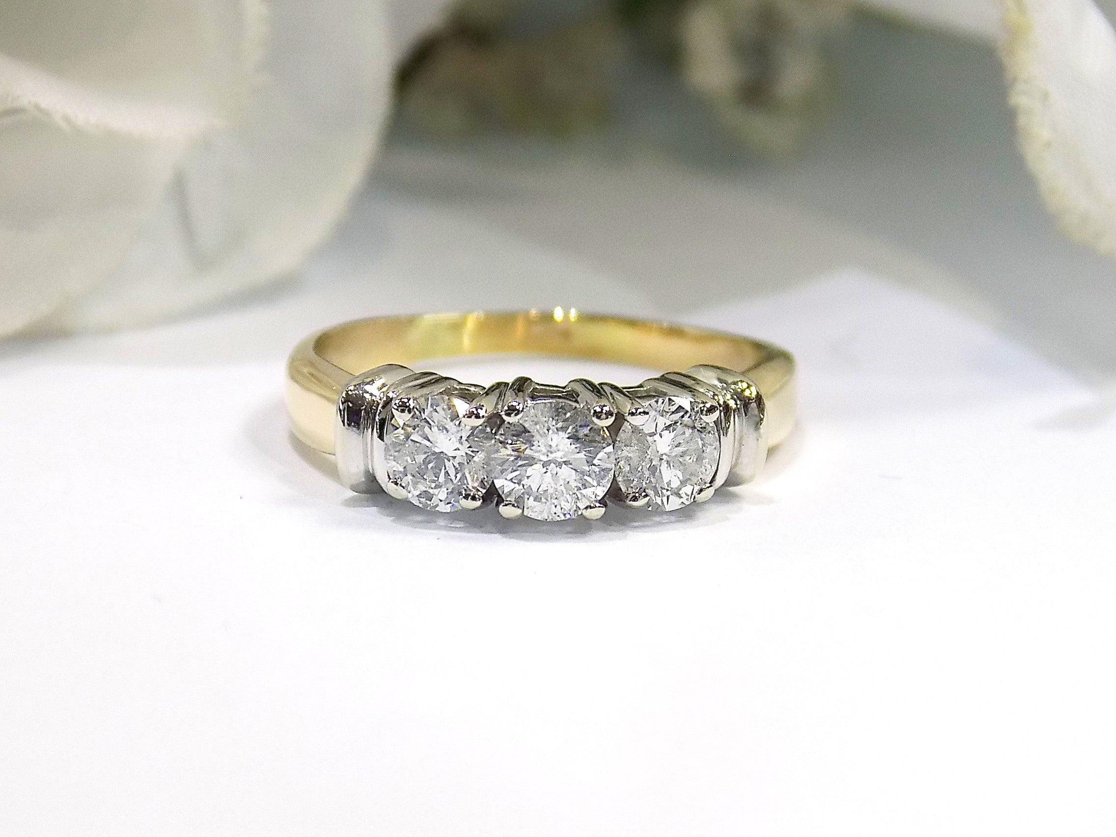1.00ct total weight 3 stone natural diamond ring in 2 tone 14K yellow and white gold. Traditionally called a past, present, future ring.