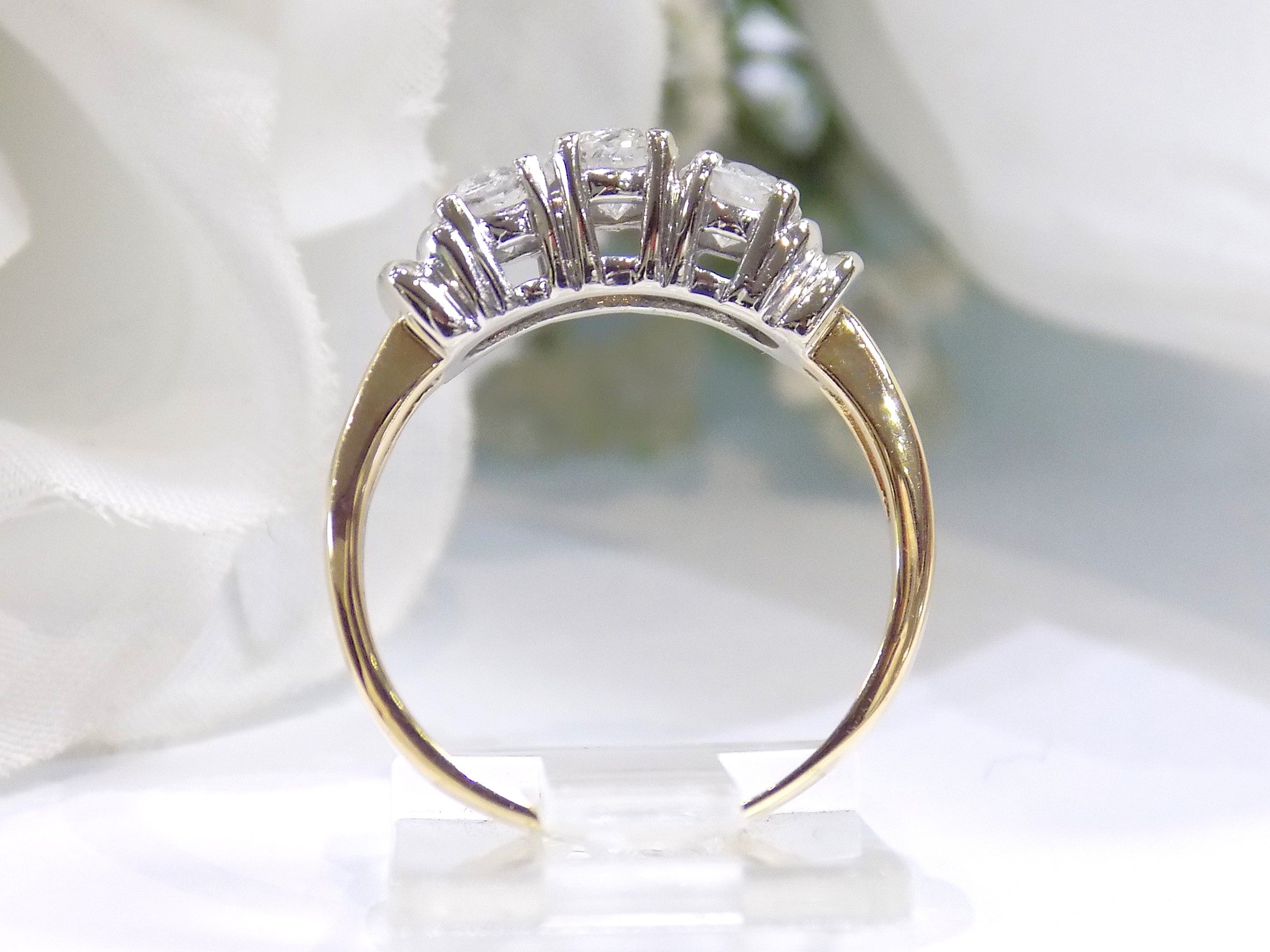 1.00ct total weight 3 stone natural diamond ring in 2 tone 14K yellow and white gold. Traditionally called a past, present, future ring. Side view