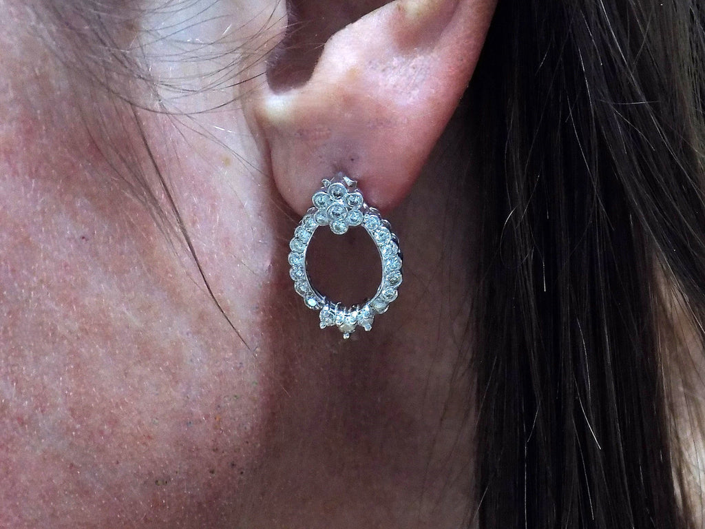 This is Victorian style natural diamond dangle post style earrings with 1.00ct total weight in diamonds set in 14K white gold in a ladies ear.