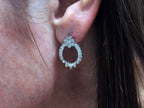 This is Victorian style natural diamond dangle post style earrings with 1.00ct total weight in diamonds set in 14K white gold in a ladies ear.