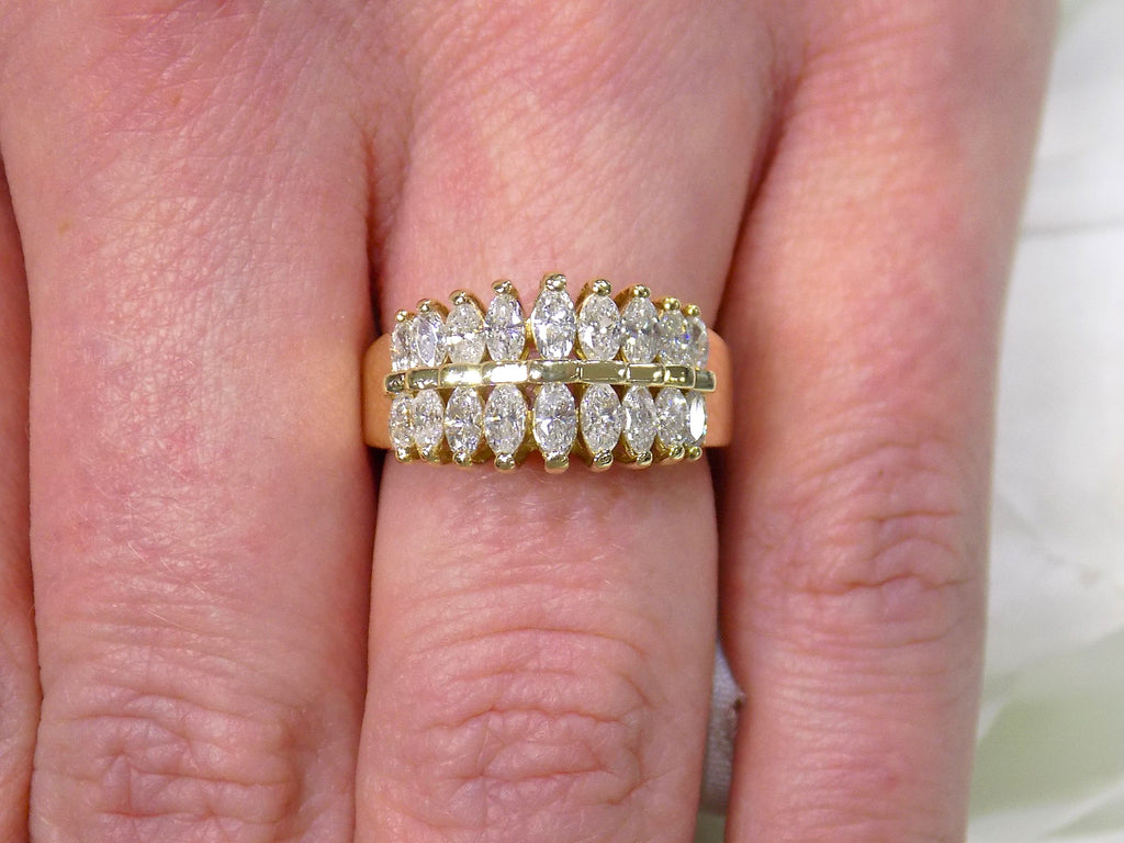This is a women's vintage 2-row natural diamond ring with 1.00ct total weight of diamonds in 14K yellow gold on a woman's finger.