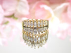 This is a women's vintage 2-row natural diamond ring with 1.00ct total weight of diamonds in 14K yellow gold on a mirrored surface with a pink floral background.