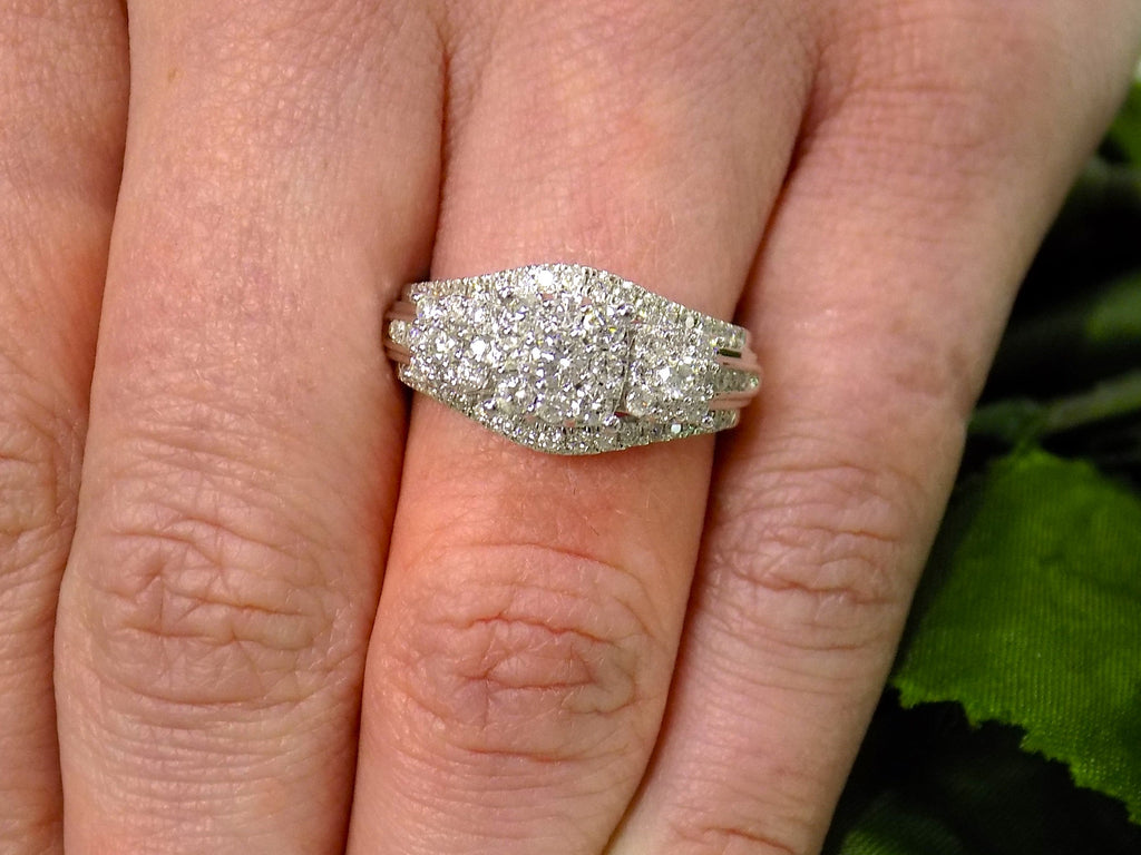 1.00ct total weight 3 stone style natural diamond cluster ring in 10K white gold on a ladies finger.