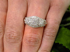 1.00ct total weight 3 stone style natural diamond cluster ring in 10K white gold on a ladies finger.