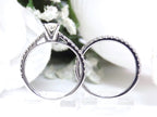 This is the side view of a natural oval shape diamond wedding set ring with matching band in white gold with a white background.