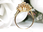 This is 1.20ct total weight natural diamond cluster cocktail ring in 14K yellow gold side view with a white background.