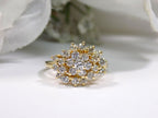 This is 1.20ct total weight natural diamond cluster cocktail ring in 14K yellow gold on a white background.