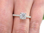 This is a straight line style 1.39ct total weight natural round brilliant diamond ring in white gold shown on a woman's finger.