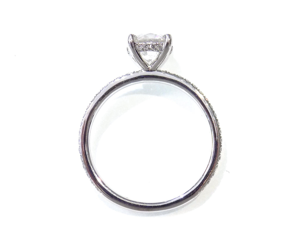 This is a side view of a straight line style 1.39ct total weight natural round brilliant diamond ring in white gold shown with a white background.