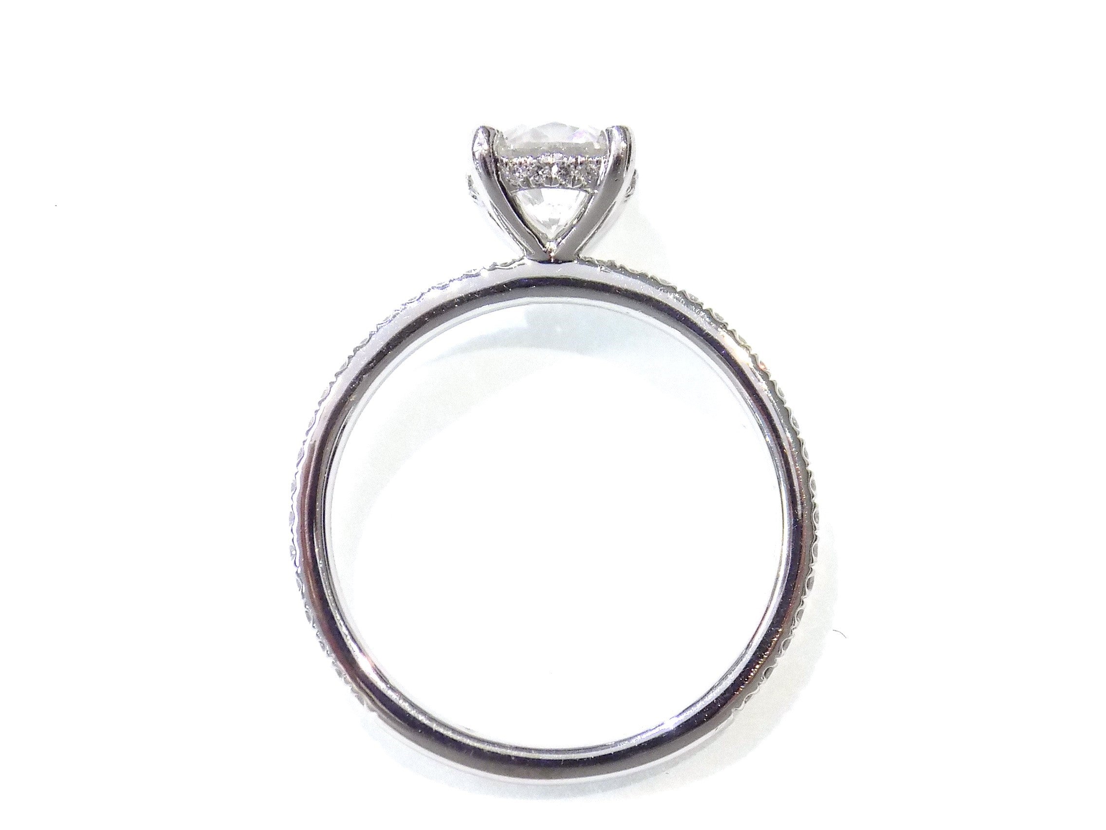This is a side view of a straight line style 1.39ct total weight natural round brilliant diamond ring in white gold shown with a white background.