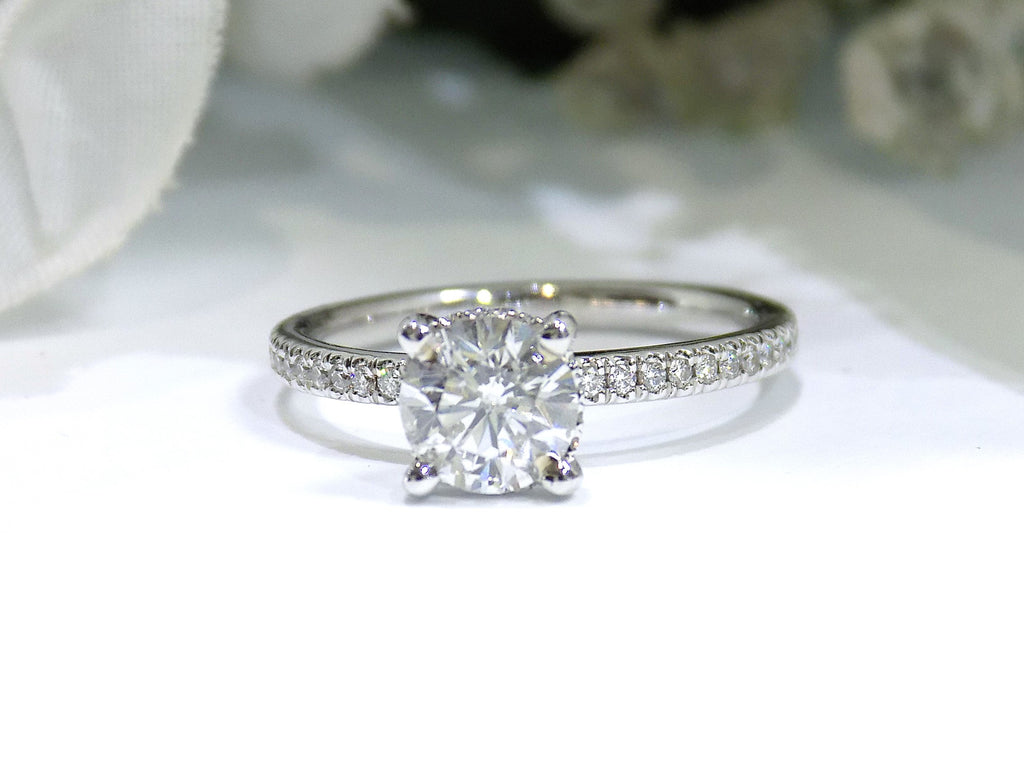 This is a straight line style 1.39ct total weight natural round brilliant diamond ring in white gold shown with a white background.