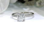 This is a straight line style 1.39ct total weight natural round brilliant diamond ring in white gold shown with a white background.