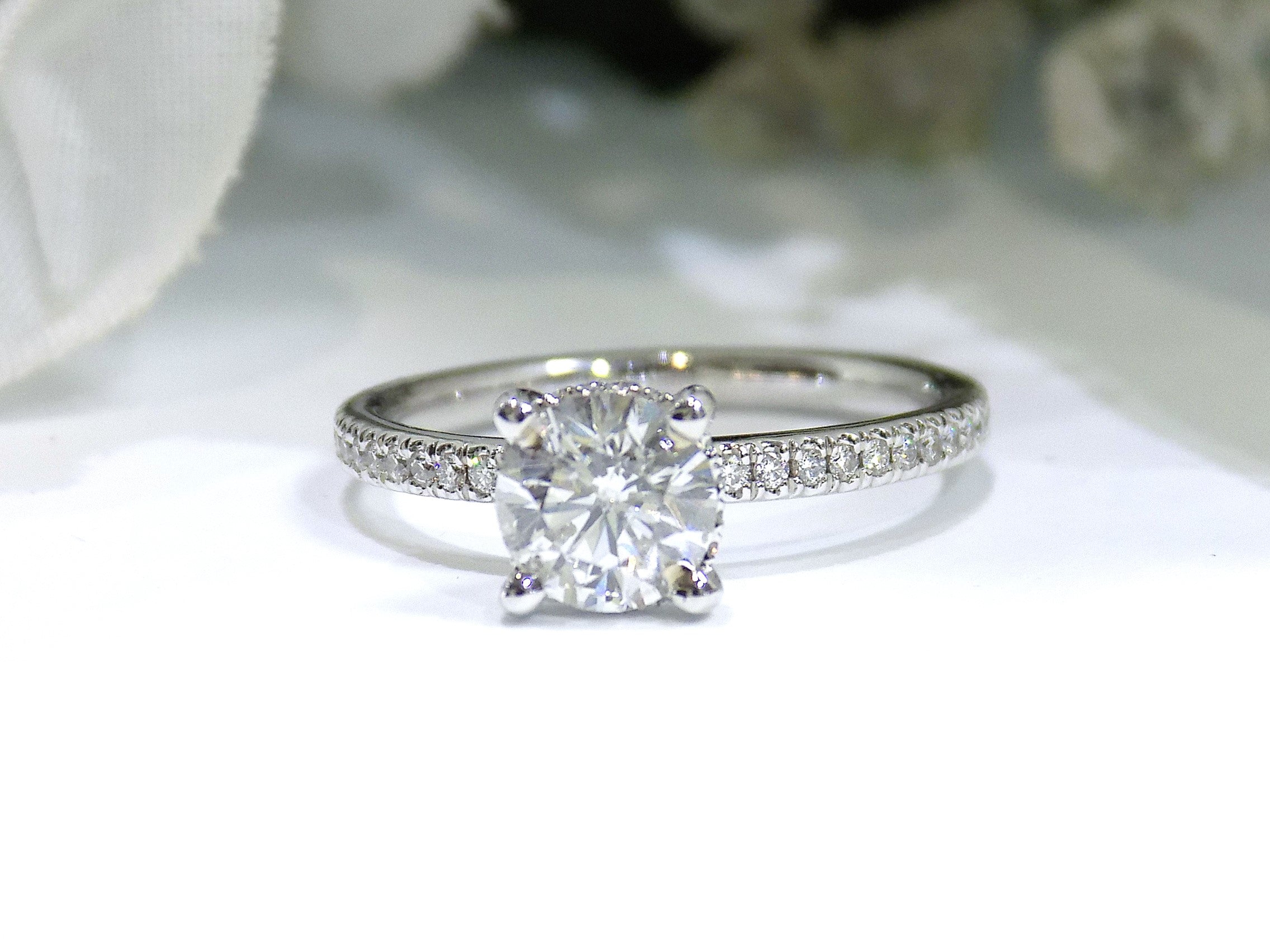 This is a straight line style 1.39ct total weight natural round brilliant diamond ring in white gold shown with a white background.