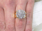 This is a women's 1.50ct total weight natural diamond 2-piece wedding set with the engagement ring and matching diamond band in yellow gold shown on a women's finger.