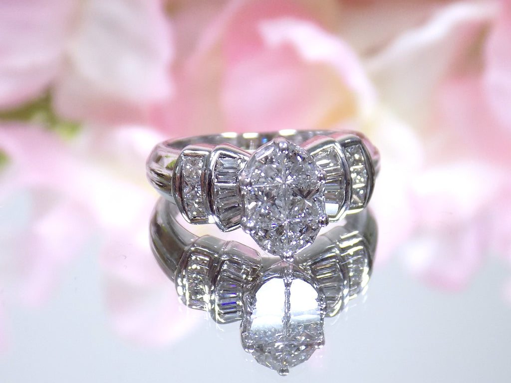 This is a 1.50ct total weight natural diamond ring in white gold from our estate collection shown with a pink mirrored background.
