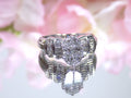 This is a 1.50ct total weight natural diamond ring in white gold from our estate collection shown with a pink mirrored background.