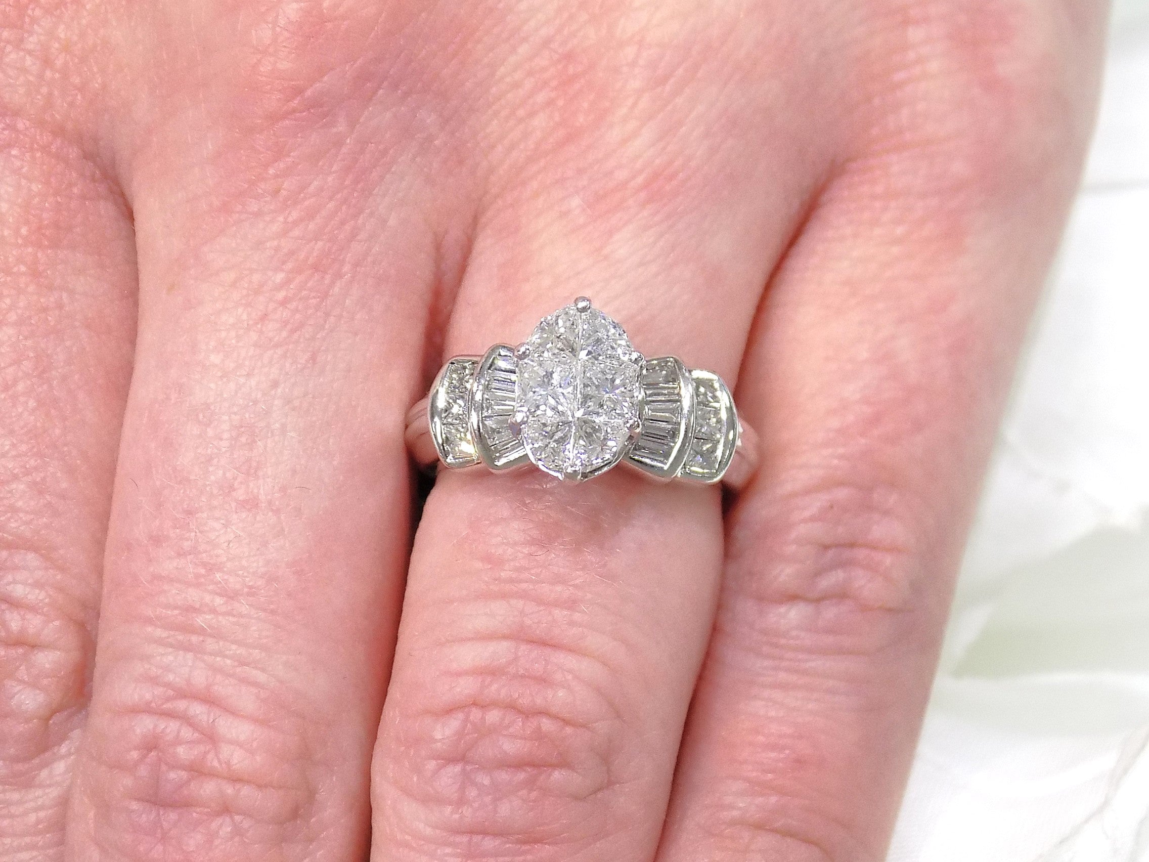 This is a 1.50ct total weight natural diamond ring in white gold from our estate collection shown on a woman's finger.
