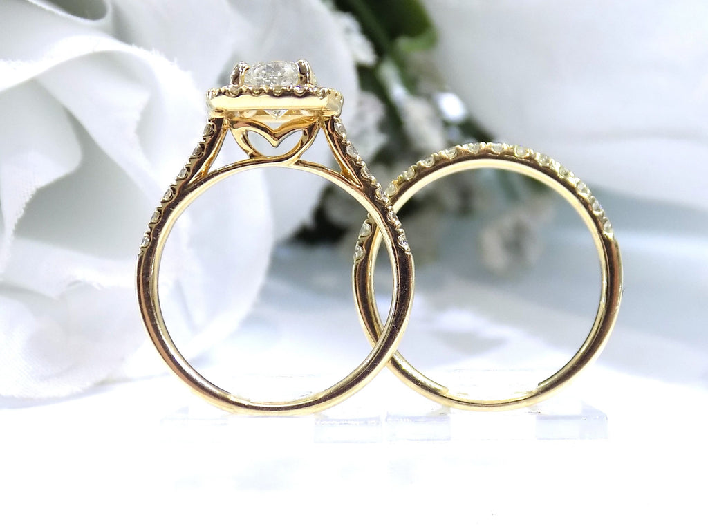 This is a side view of a halo style 2-piece wedding set which includes the engagement ring and a matching band for a total of 1.77ct in natural round diamonds shown side by side with white flowery background.