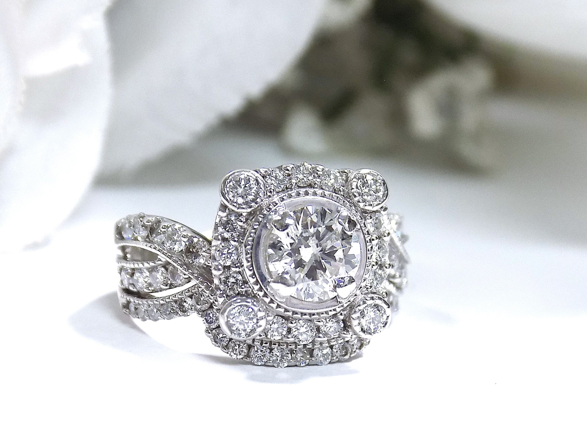 The is a 1.95ct total weight natural 2-piece natural round diamond wedding set with engagement ring and matching band already tacked together from our estate collection in white gold with white background. 