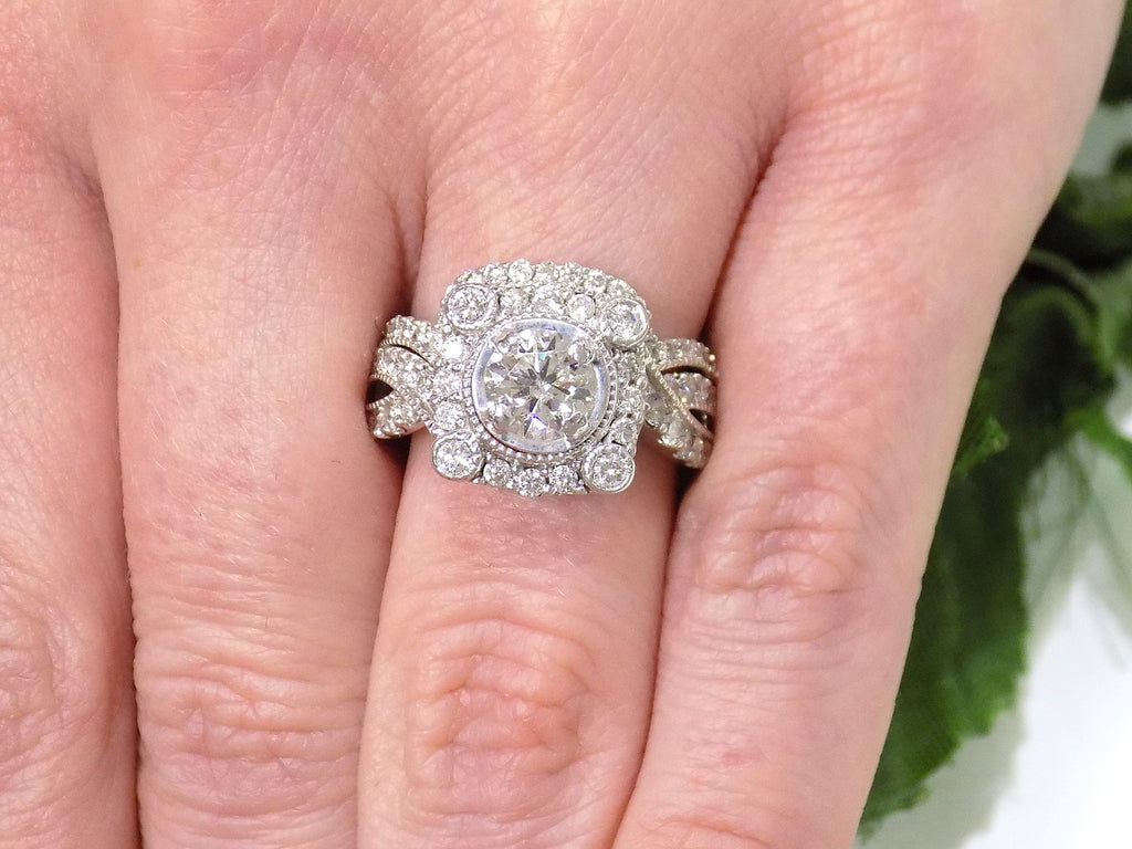 The is a 1.95ct total weight natural 2-piece natural round diamond wedding set with engagement ring and matching band already tacked together from our estate collection in white gold shown on a woman's finger.