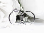 This is a two piece diamond wedding set with the ring and matching band in white gold shown from a side view white background. 