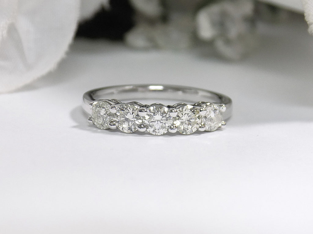 This is a 5-Stone natural diamond band in white gold with a white gold background.