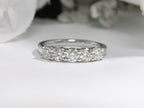 This is a 5-Stone natural diamond band in white gold with a white gold background.