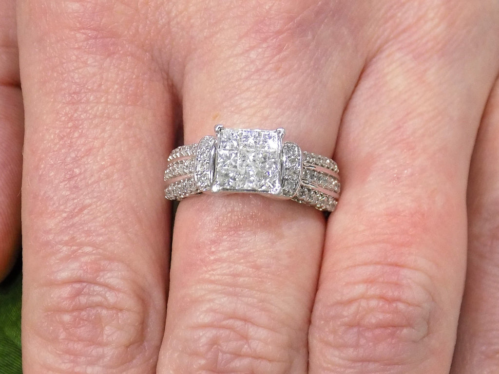 This is a 1.00ct total weight natural diamond ring in white gold shown on a woman's finger.