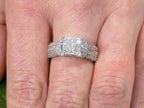 This is a 1.00ct total weight natural diamond ring in white gold shown on a woman's finger.