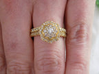 2-Piece yellow gold and diamond wedding set with matching band shown on ladies' finger.