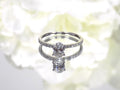 This a 1ct total weight natural oval shape diamond set on a straight line diamond band in white gold.