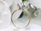 This is side view of a high quality 1.00ct natural pear shape diamond solitaire ring in yellow gold with a white background.