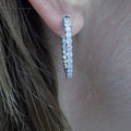 This is a 2.00ct total weight in and out diamond hoop earrings in 14K white gold earrings in a ladies ear.