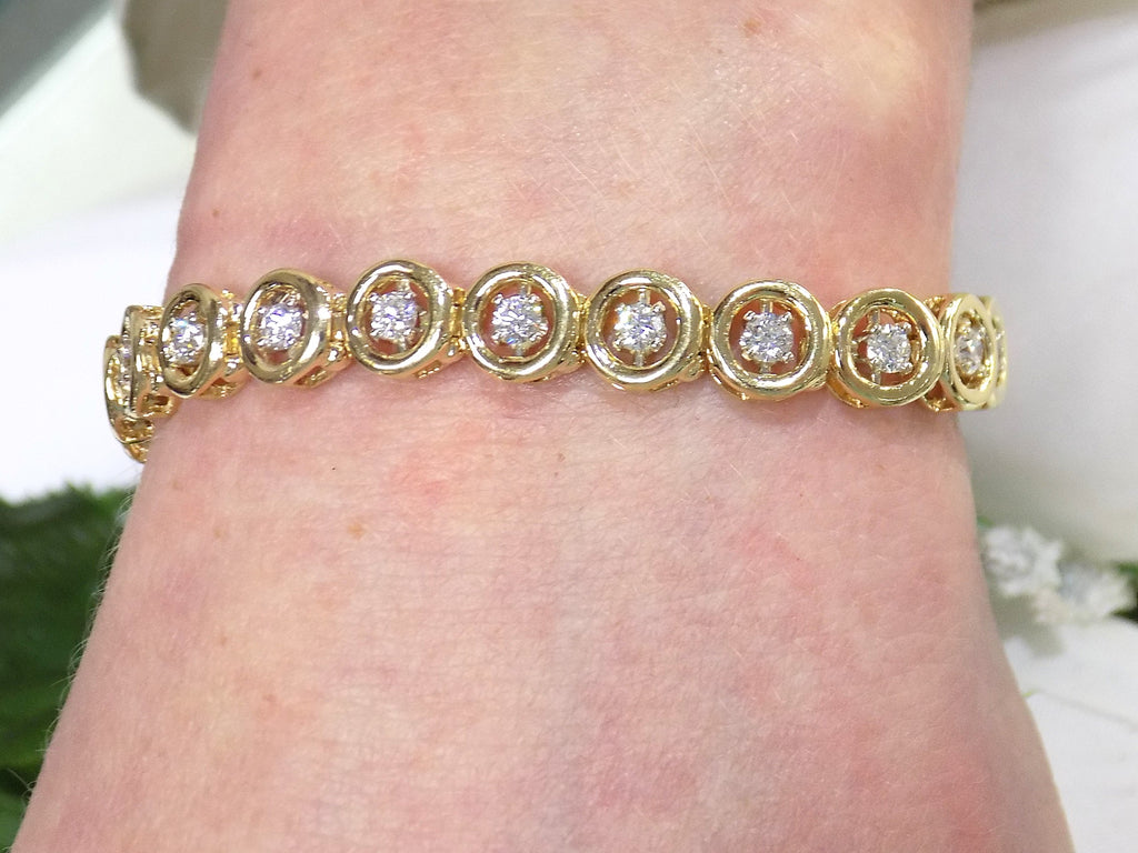 This is a 2.00ct total weight diamond bracelet in 14K yellow gold on a ladies wrist