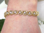 This is a 2.00ct total weight diamond bracelet in 14K yellow gold on a ladies wrist