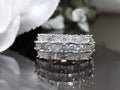 This is a vintage 2.00ct total weight round brilliant and baguette diamond band in two tone 14K yellow and white gold on a black background.