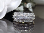 This is a vintage 2.00ct total weight round brilliant and baguette diamond band in two tone 14K yellow and white gold on a black background.