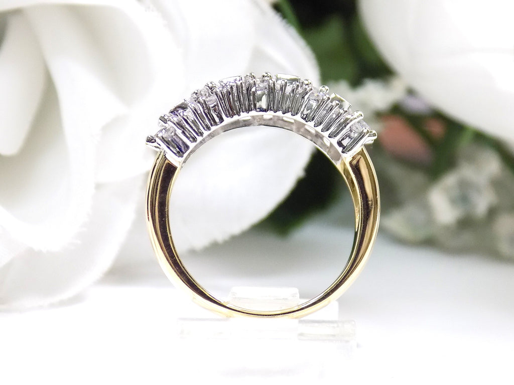 This is a vintage 2.00ct total weight round brilliant and baguette diamond band in two tone 14K yellow and white gold side view on a white background.