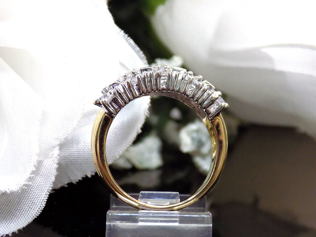 This is a vintage 2.00ct total weight round brilliant and baguette diamond band in two tone 14K yellow and white gold side view on a black and white background.