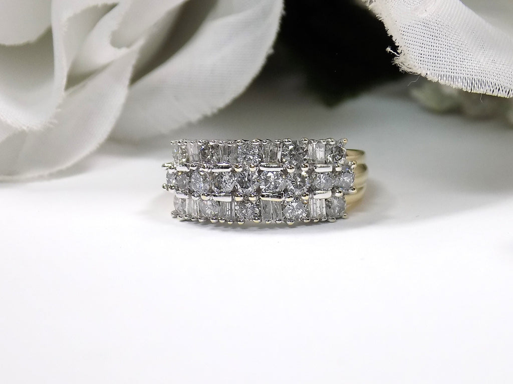 This is a vintage 2.00ct total weight round brilliant and baguette diamond band in two tone 14K yellow and white gold on a white background.
